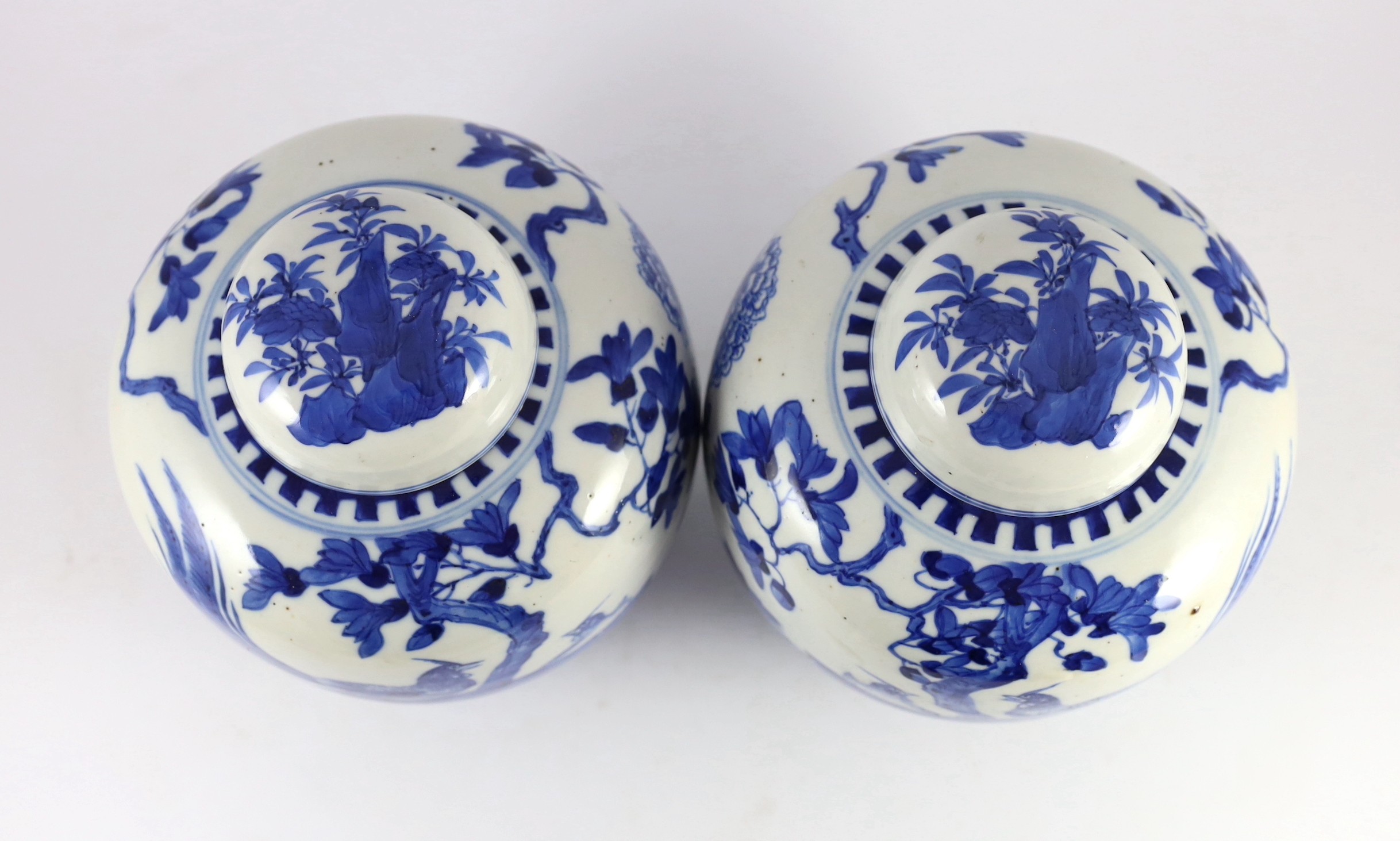 A pair of Chinese blue and white jars and covers, 19th century, 25cm high